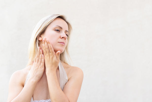 woman doing facial exercises