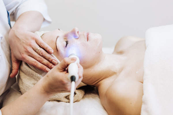 woman getting facial laser treatment