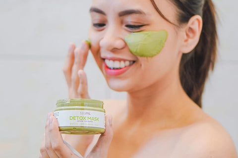 Girl applying green tea detox mask