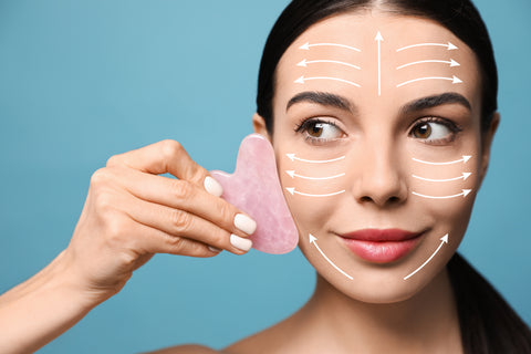 Woman using guasha on face directions of how to use guasha facial roller