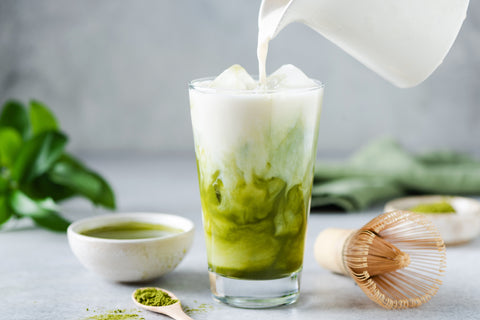 cold milk poured into matcha green tea matcha latte