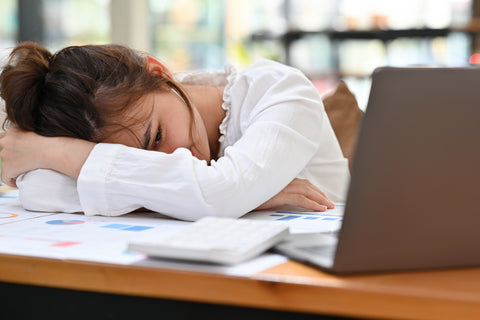 woman napping at desk during the daytime