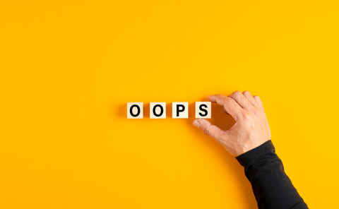 letter cubes spelling out "oops"