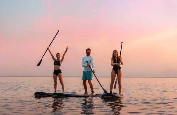 3 friends out paddle boarding