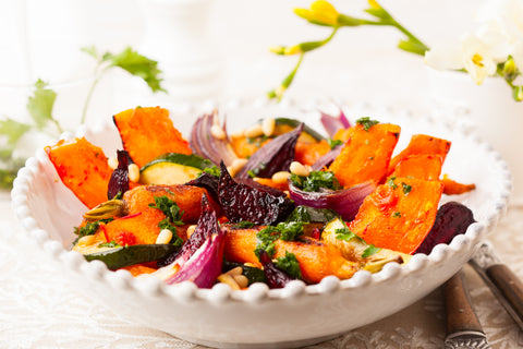 Roasted winter veggies in a white bowl