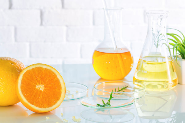 vitamin c as an orange and in a beaker