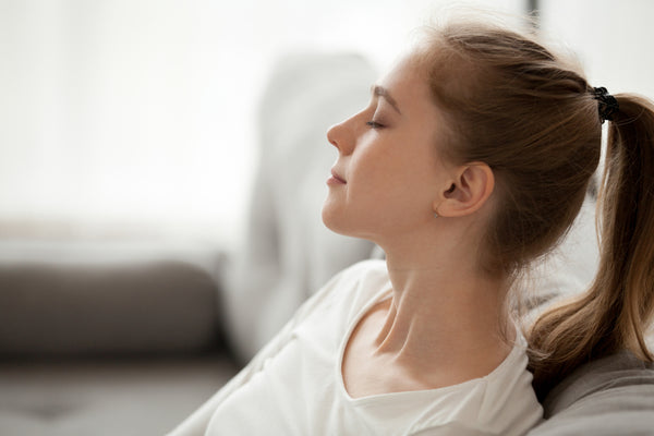 young woman practicing breathing calmly