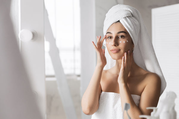 woman applying eye cream in the morning