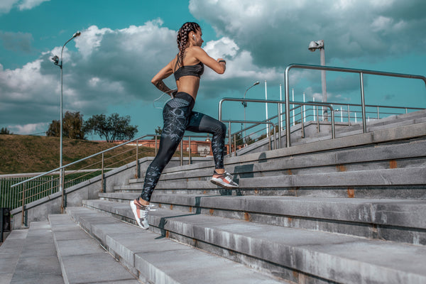 woman with healthy bones running up stairs