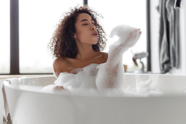 woman soaking before shaving her legs