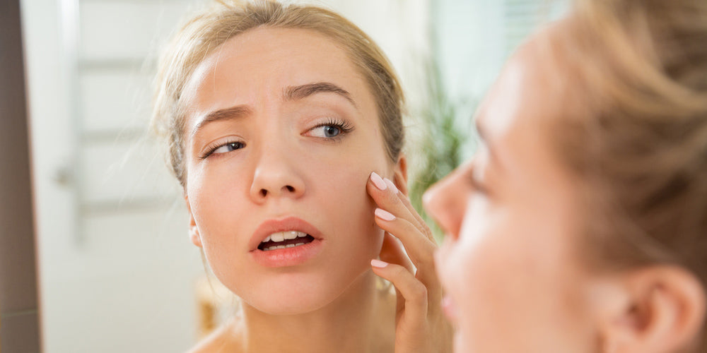 Woman checking her irritated skin