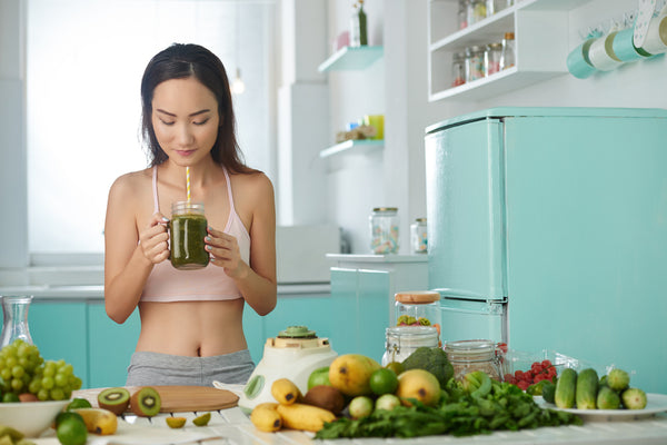 woman drinking a healthy green smoothie