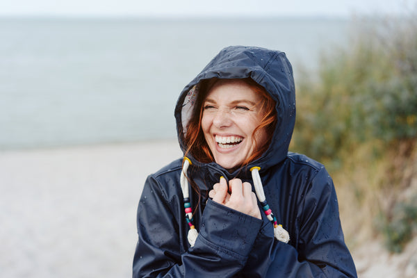 woman wearing a coat at the beach