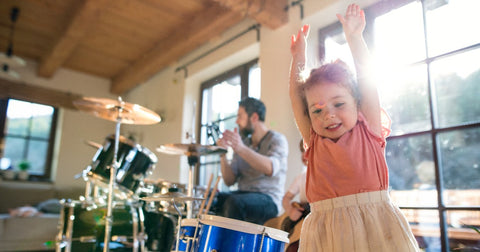 Father on drums while his daughter dances
