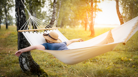 person asleep on a hammock