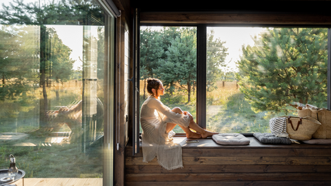 lady enjoying natural light in her home