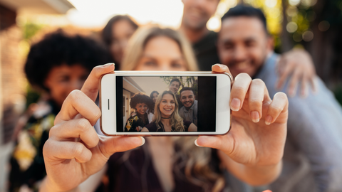 lady taking a selfie of a group of people