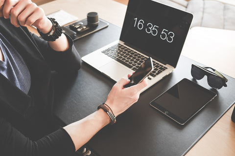 person checking phone at desk