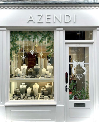 A jewellery store window with Christmas decorations