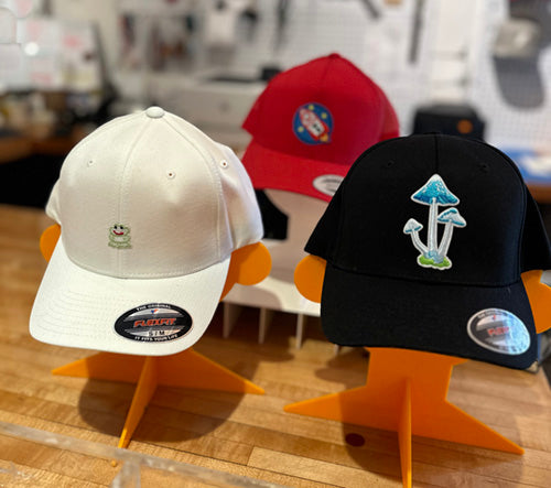 Photo of three caps with iron-on patches