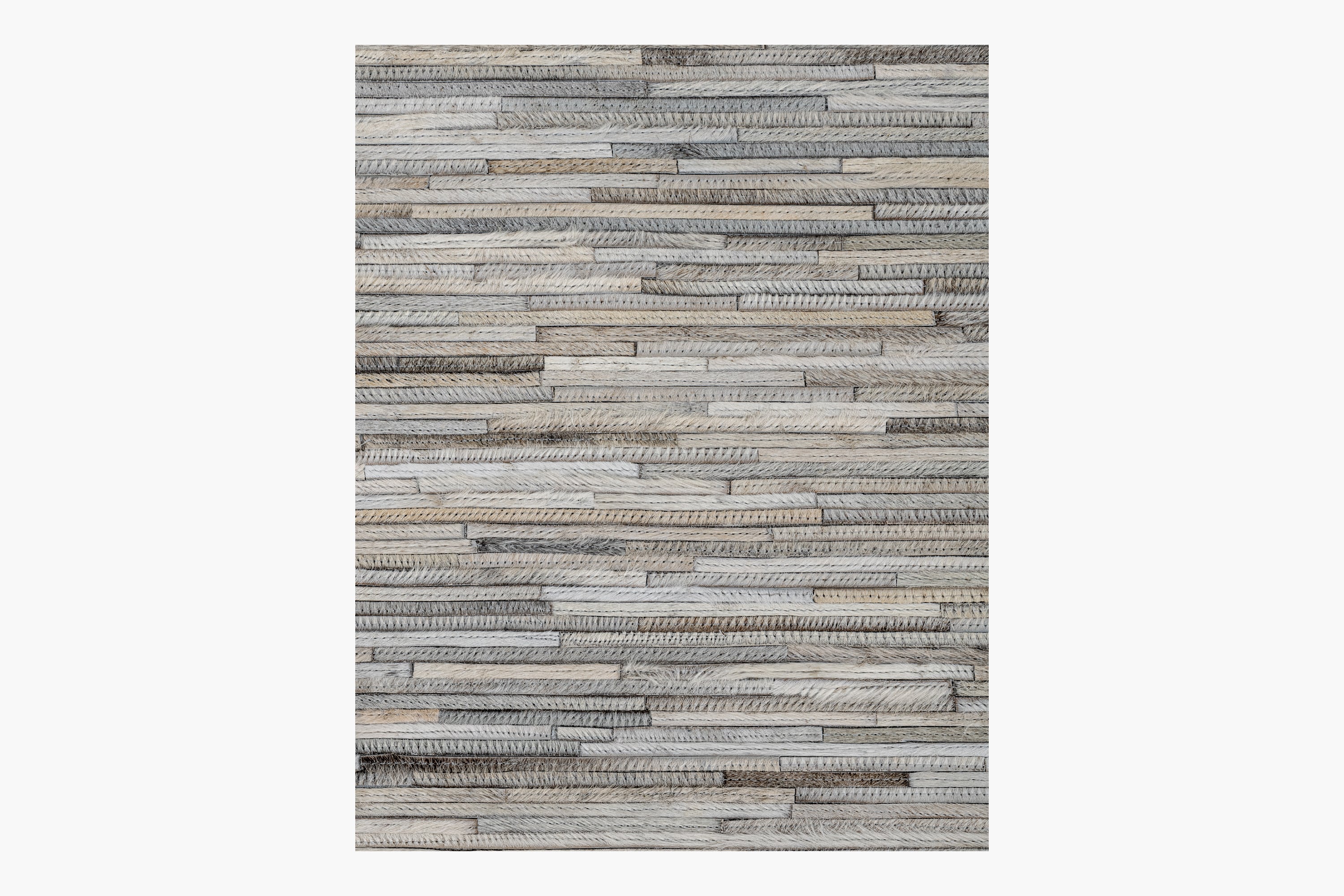 Tall rectangular piece of wall art featuring a horizontal pattern of stacked wooden planks in varying shades of gray and brown. The wood grains and textures are visible, adding a rustic, natural feel to the design, similar to the artisanal quality found in the Ben Soleimani Ladro Hide – Grey collection.