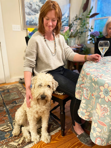 Woman with dog, wine, necklace