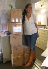 Stefanie Wolf with a stack of boxes of jewelry heading for UncommonGoods