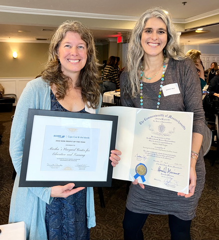 Stefanie Wolf of Stefanie Wolf Designs and Holly Bellebuono of the Martha's Vineyard Center for Education and Training hold up their 2022 Score Awards for Small Business Excellence and Nonprofit of the year, respectively