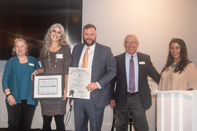 Stefanie Wolf receiving the 2022 SCORE Small Business Excellence Award with Massachusetts State Senator, Julian Cyr