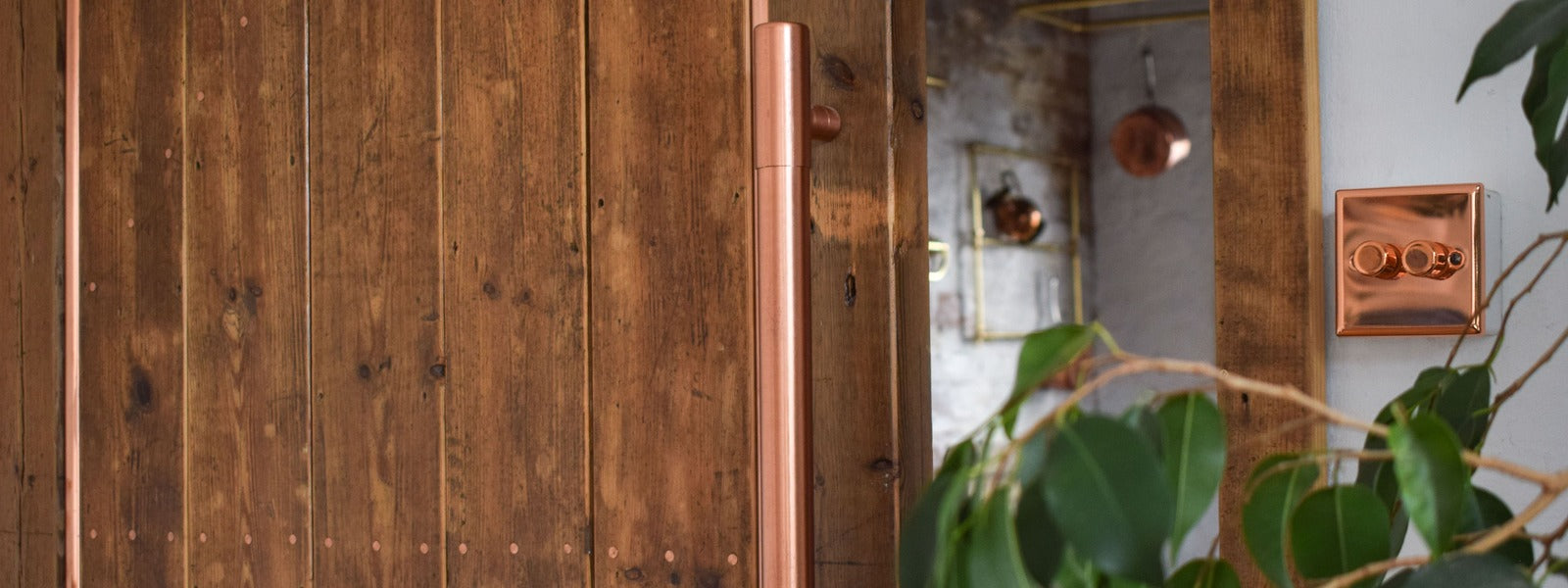 copper front door handle on a sliding wooden door