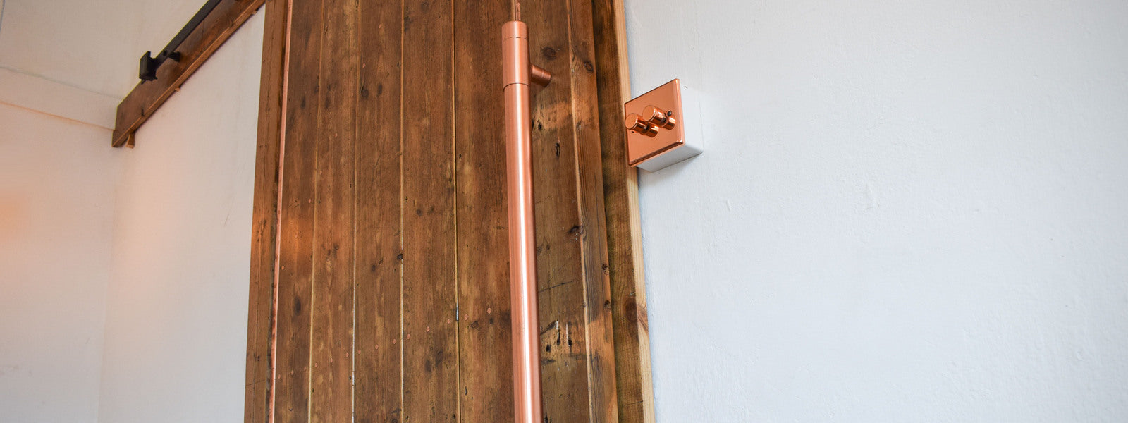 reclaimed wooden door completed with copper handle