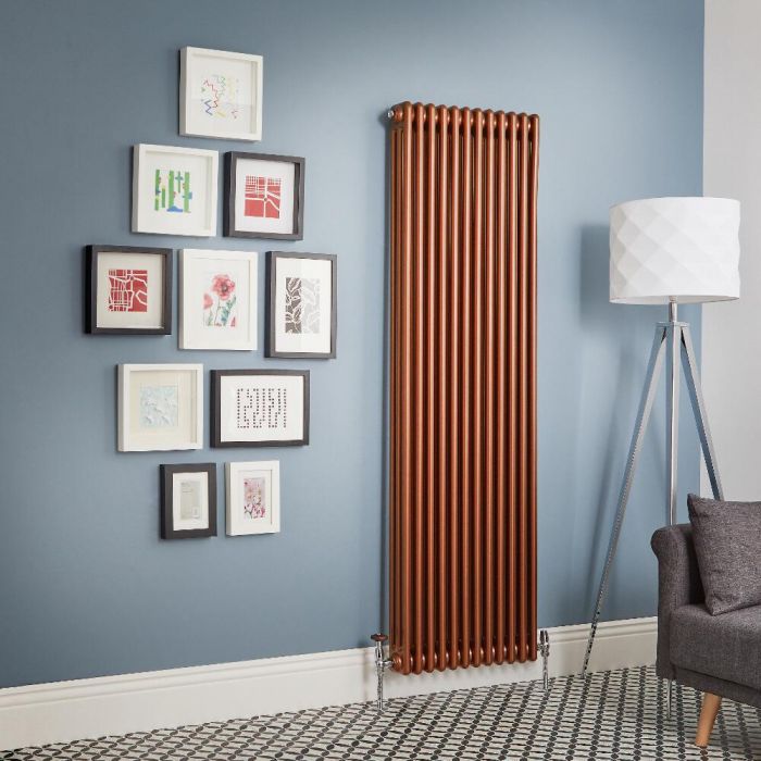 large copper radiator on blue wall with art drawings