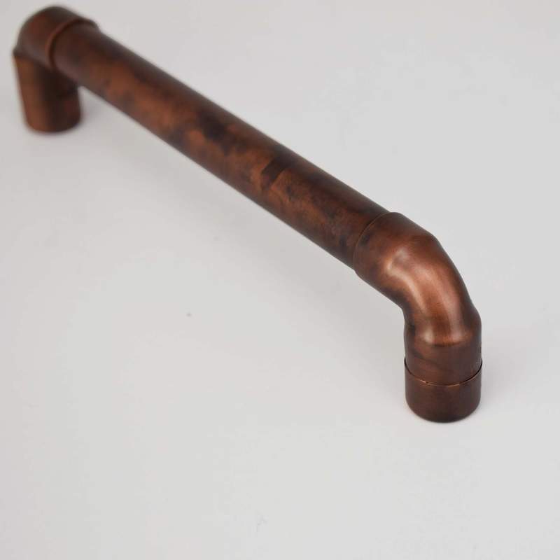 copper pull handle on white backdrop 