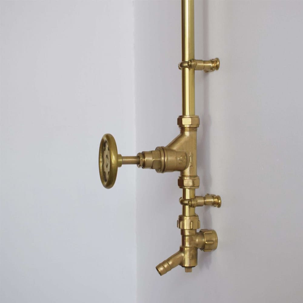 Brass drainage valves photographed on a brass garden shower