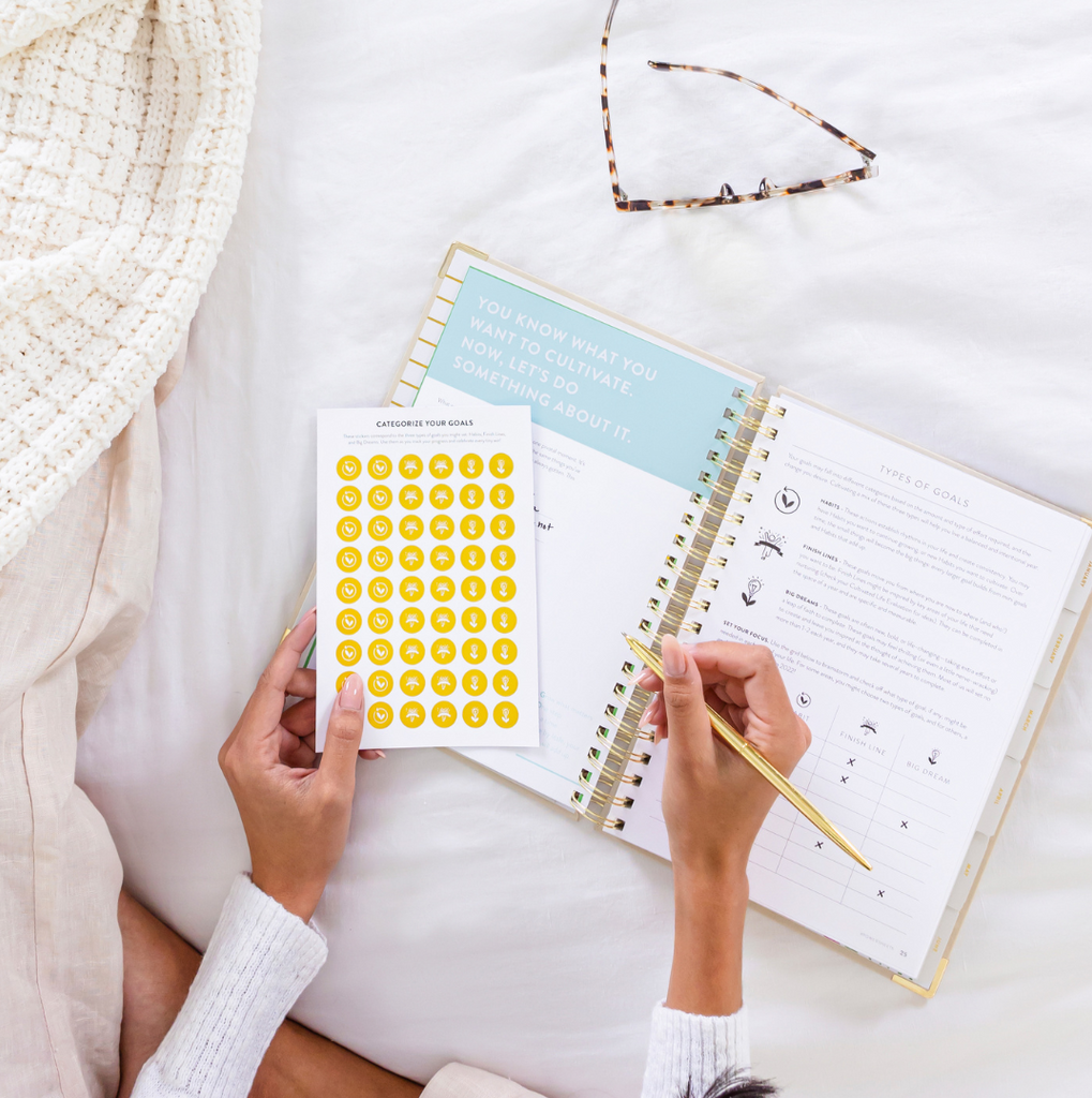 PowerSheets goal planner on a bed