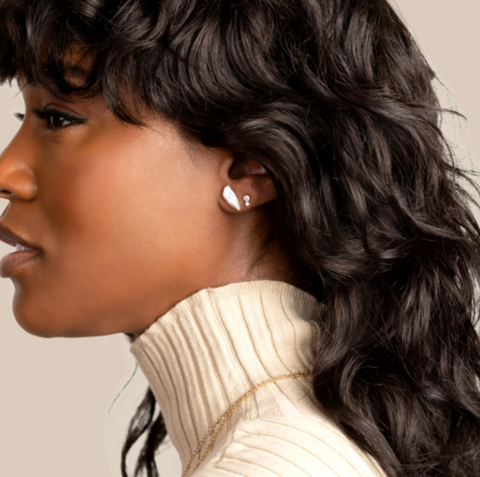 woman wearing WHITE/SPACE earrings & turtle neck