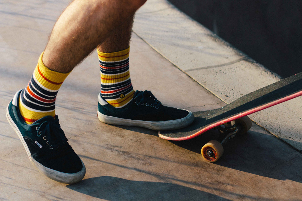 Close up of skateboarder's shoes and socks.