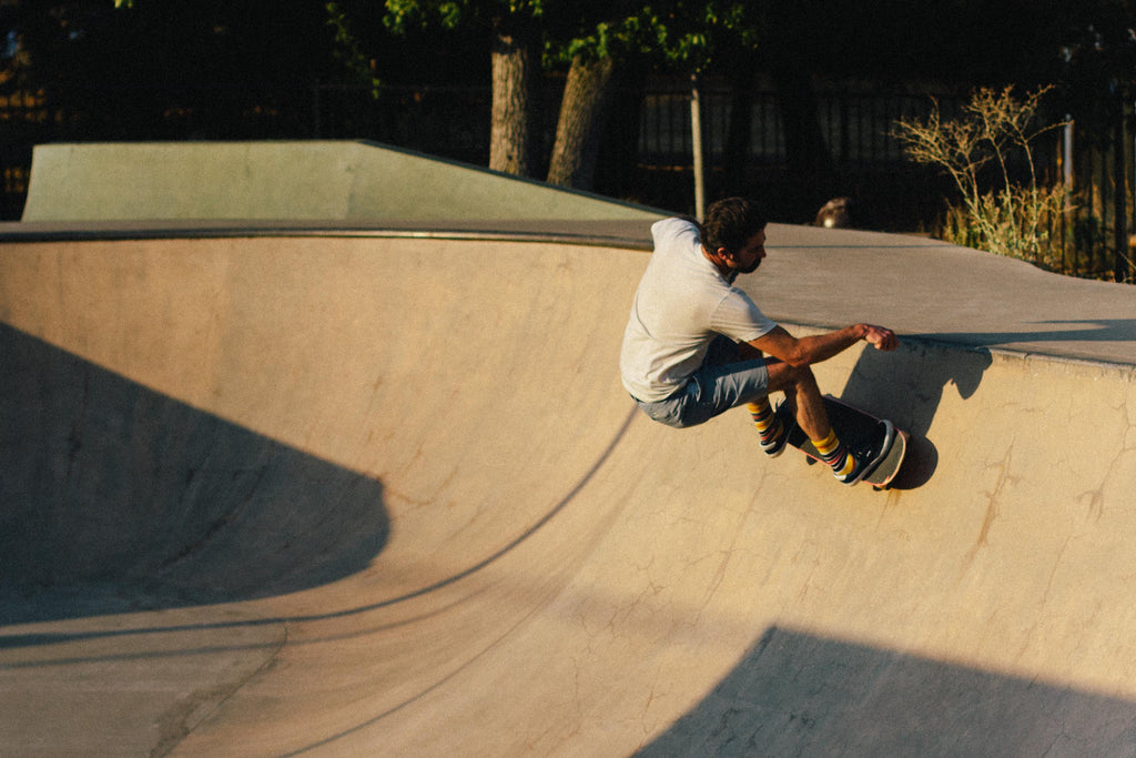 Skateboarder riding a bowl.