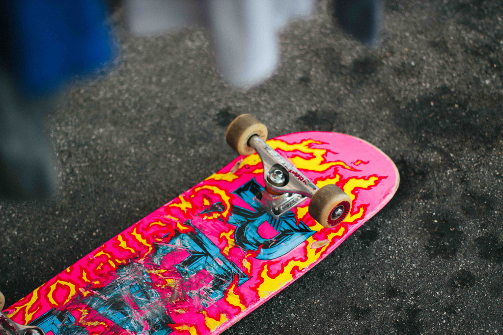 a pink skateboard on the ground