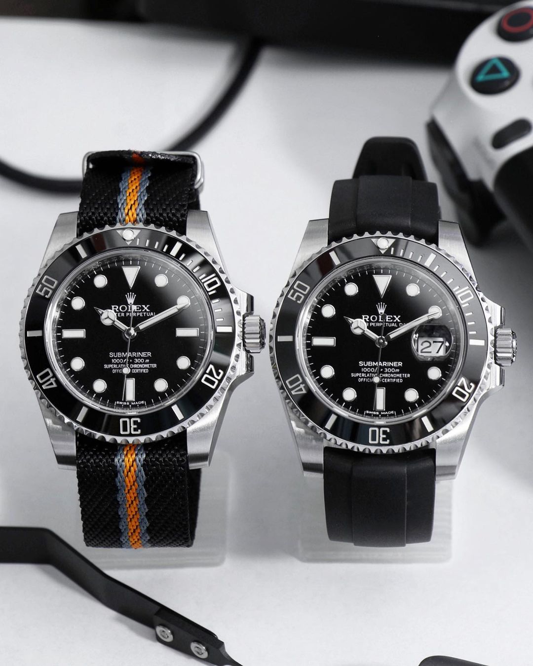two rolex submariner watches one on nato and one on rubber