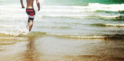 guy running in ocean