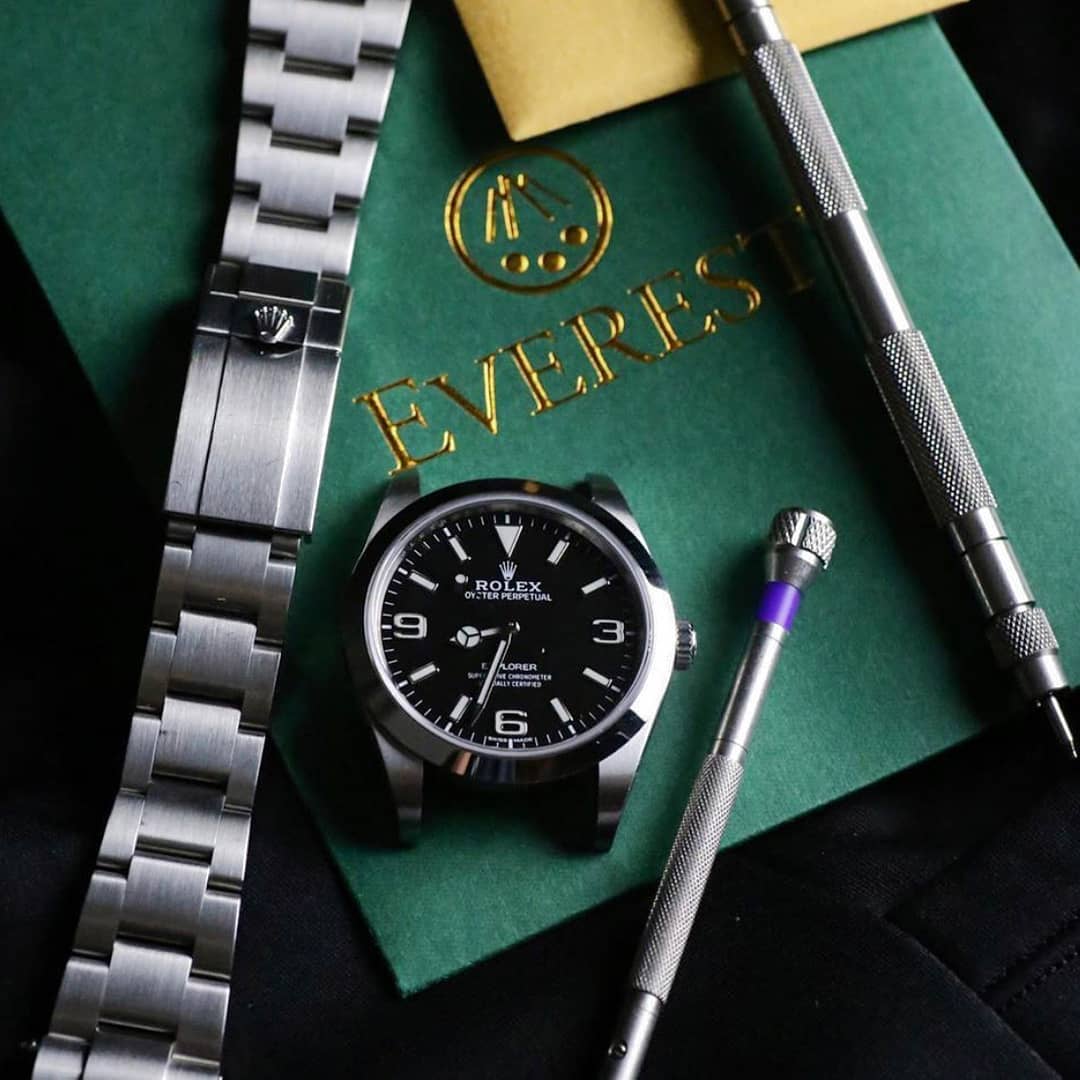 premier oyster bracelet watch tool kit which includes a screwdriver and a spring bar tool next to a rolex watch with the original bracelet removed