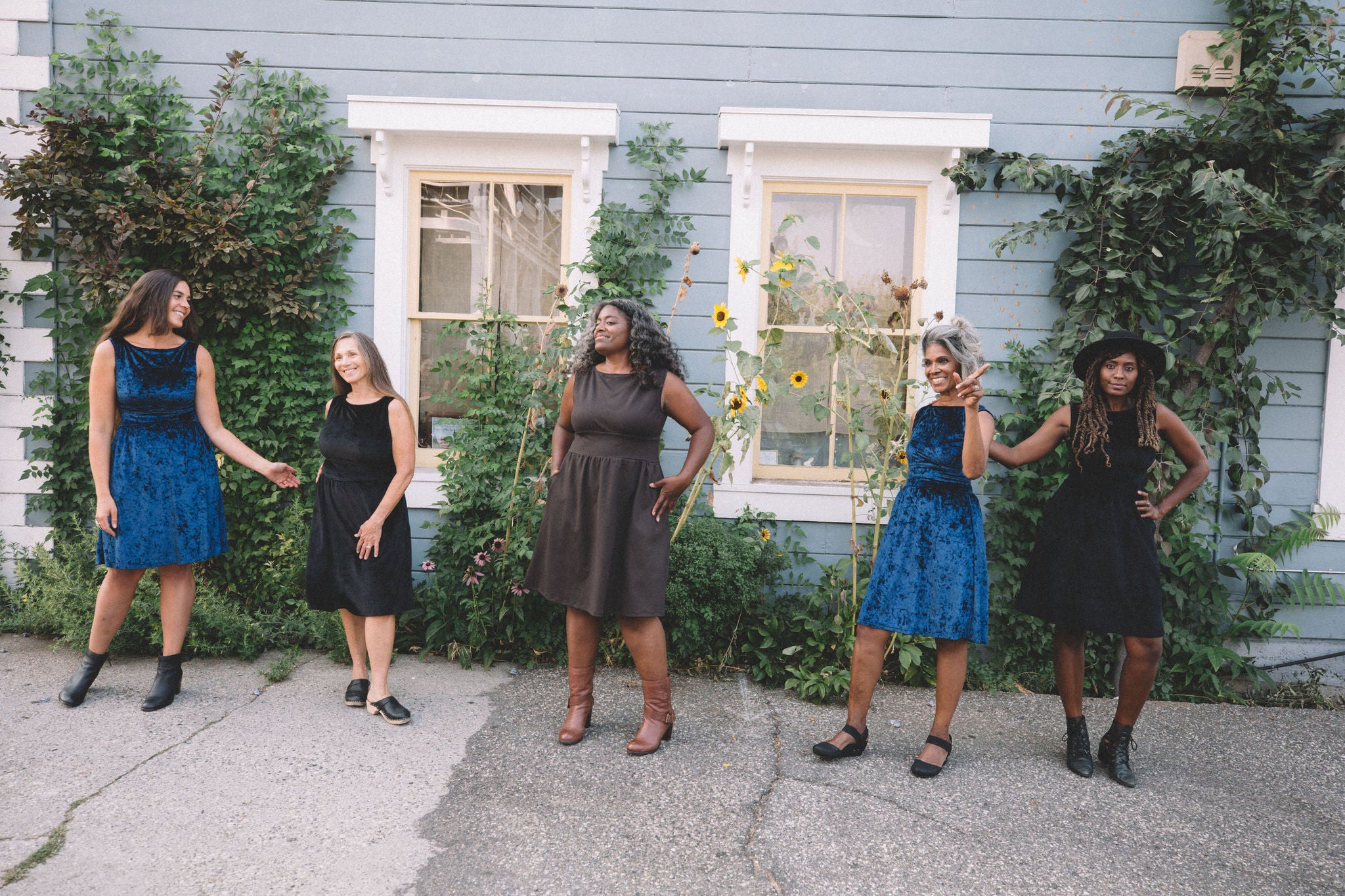 group of women wearing sleeveless dresses with sunflowers 