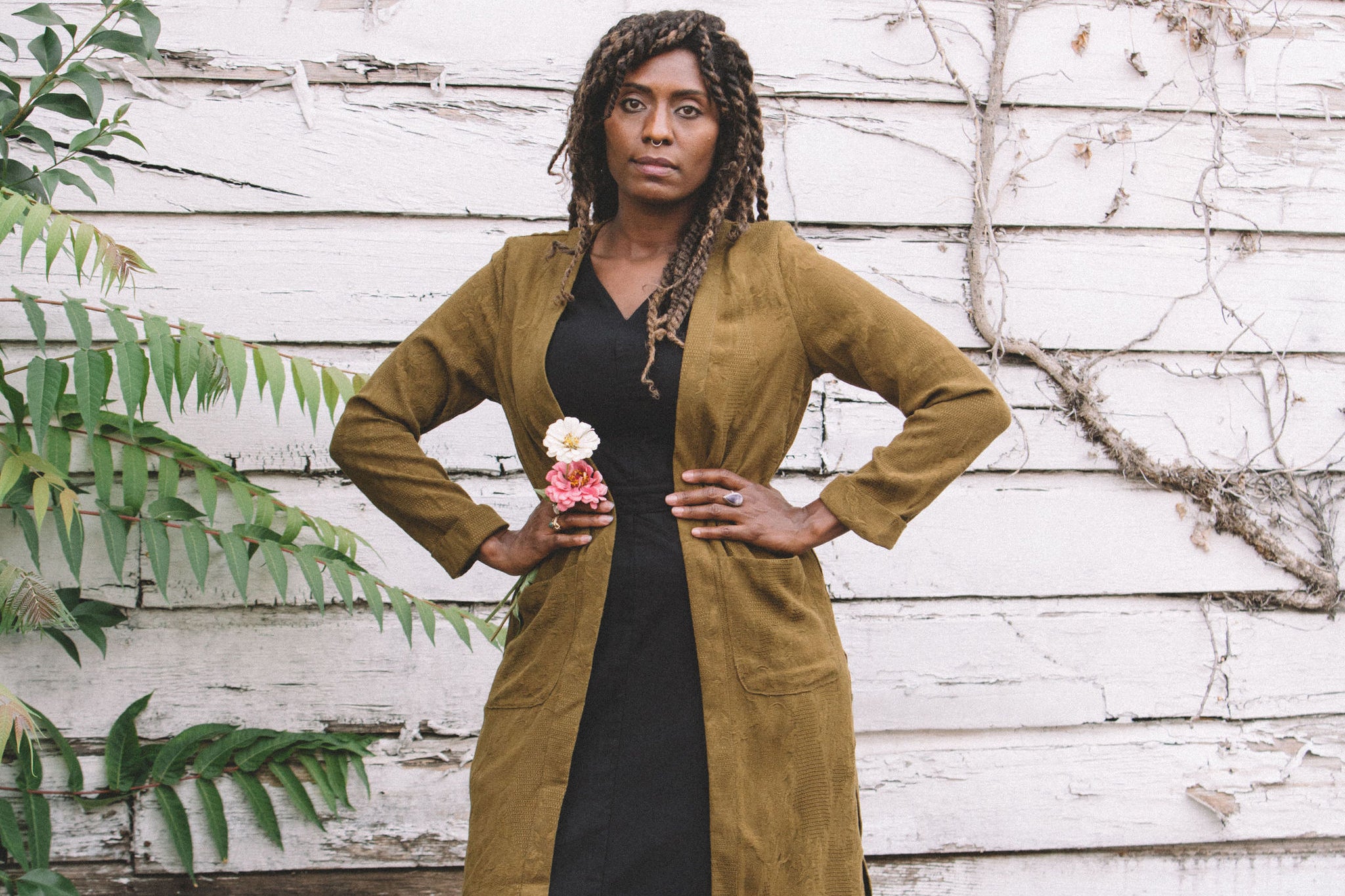 long jacquard cardigan with a woman wearing it and a pink flower  