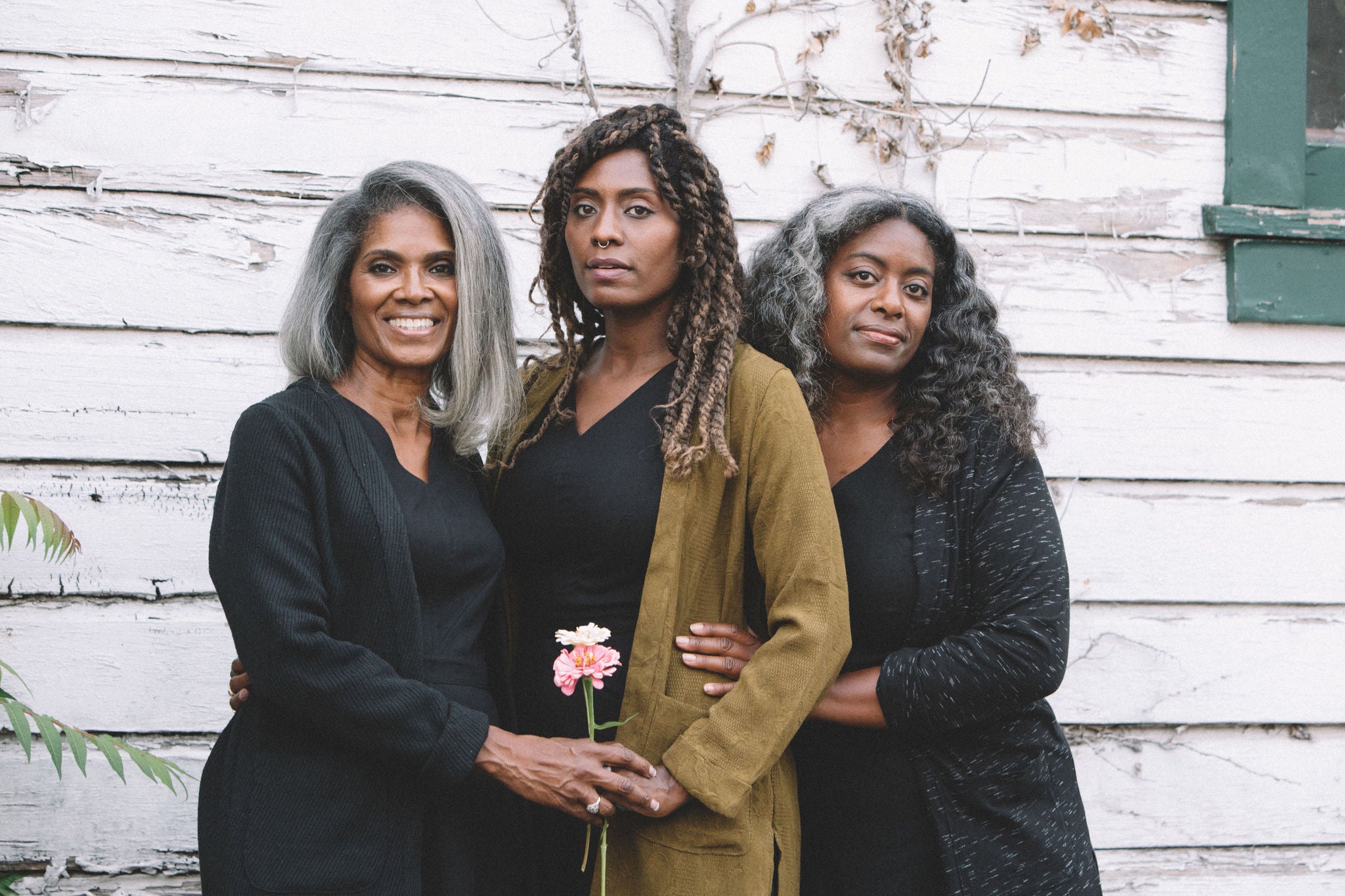 family of women all wearing the same cardigan 