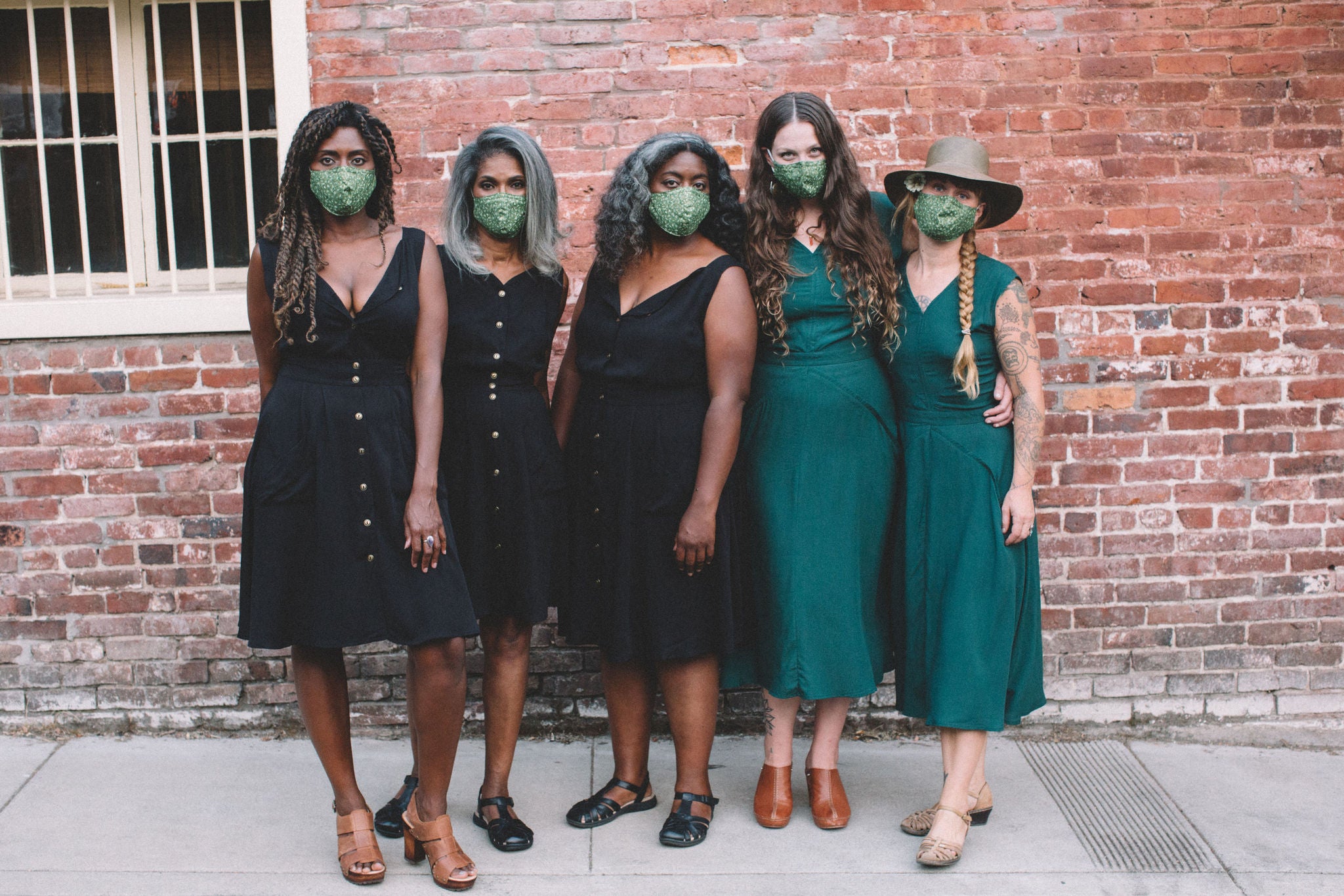 woman in dresses wearing masks 