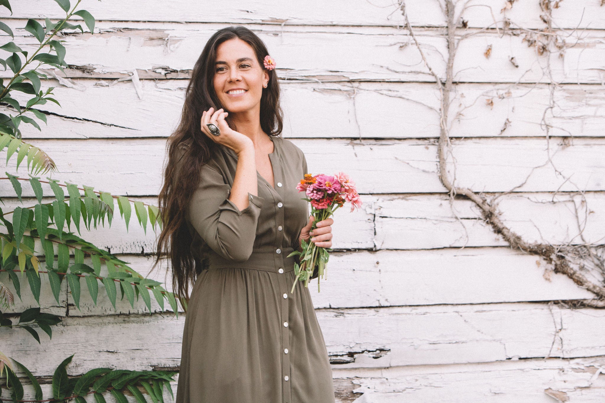 white woman with long hair in  along green vera dress 