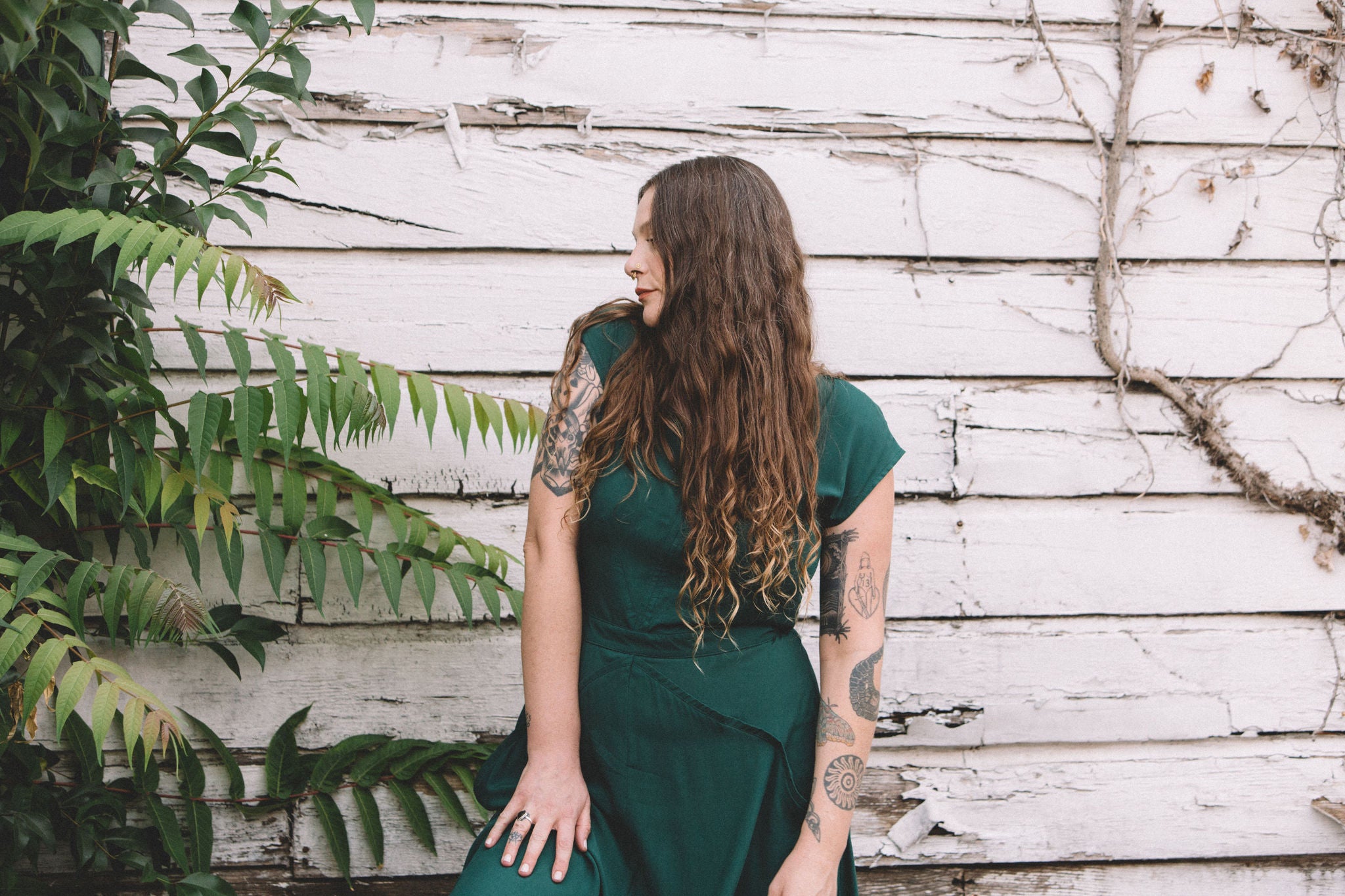 emerald green xena dress on a white woman with long hair 