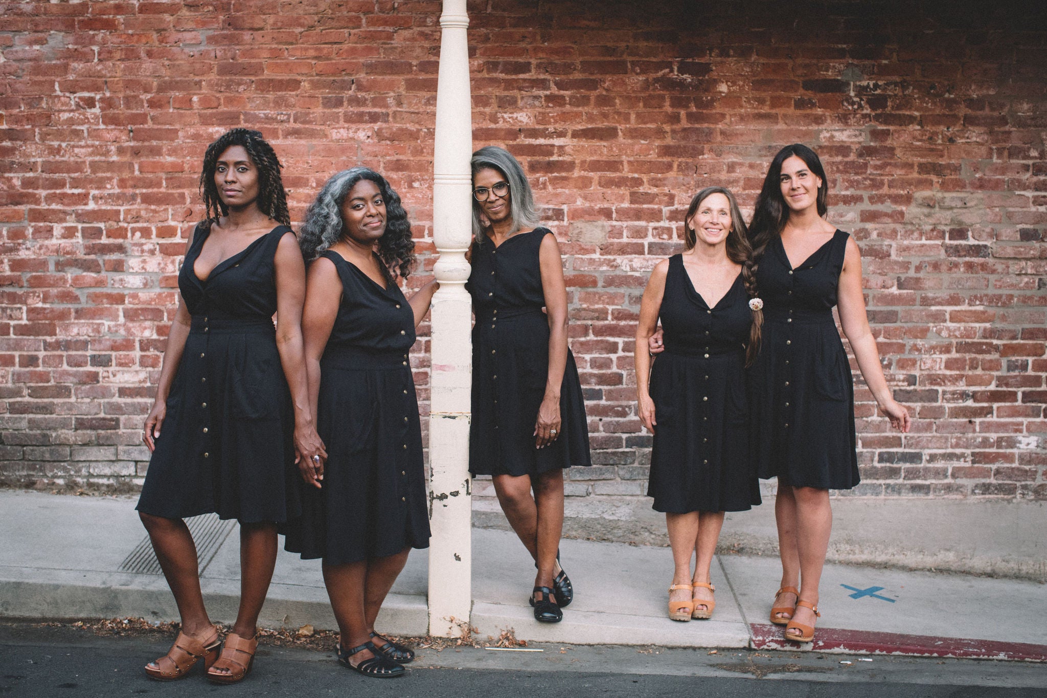 group of women in black sheet dresses 