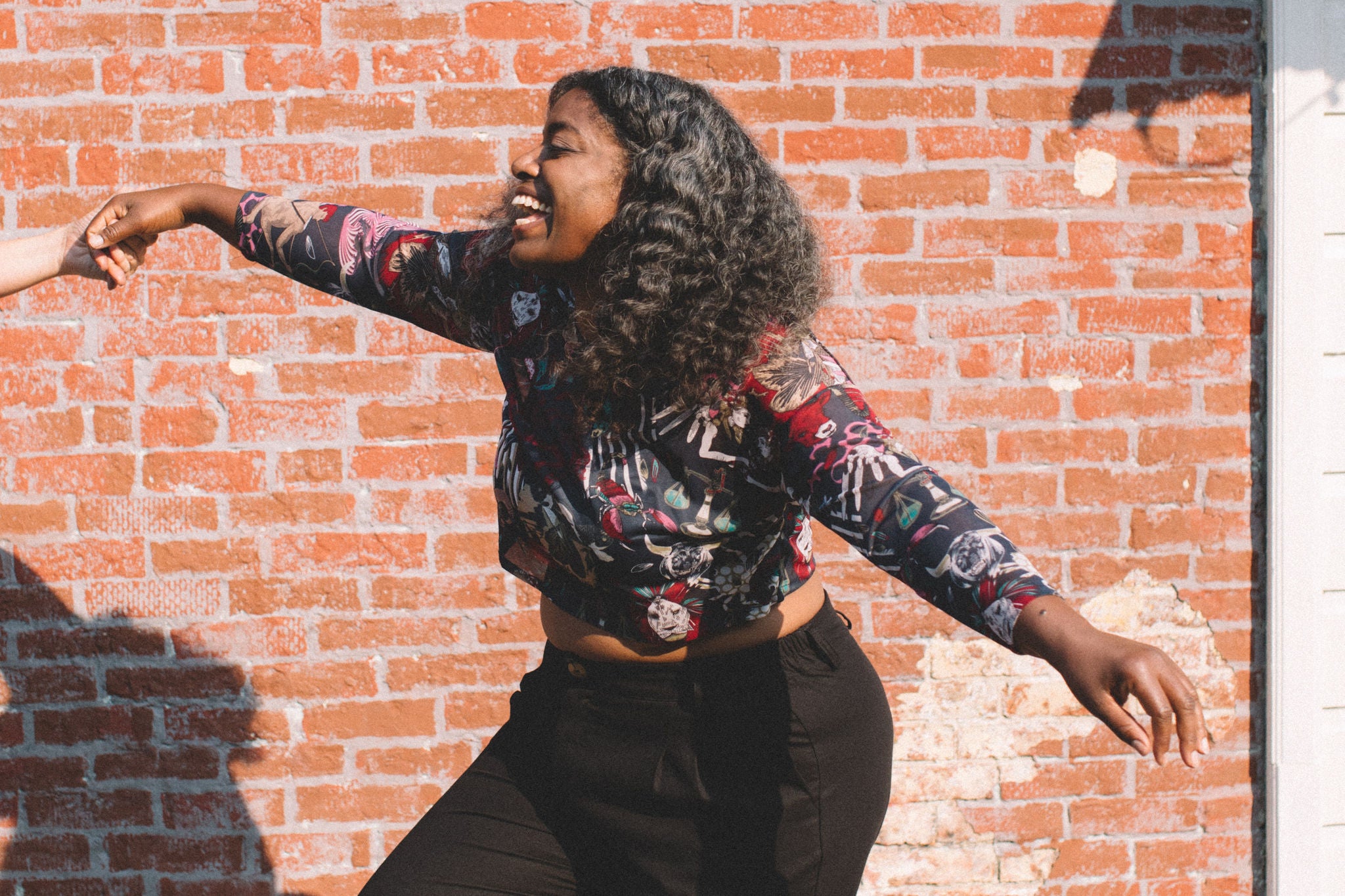 woman flying in a long sleeve crop top 